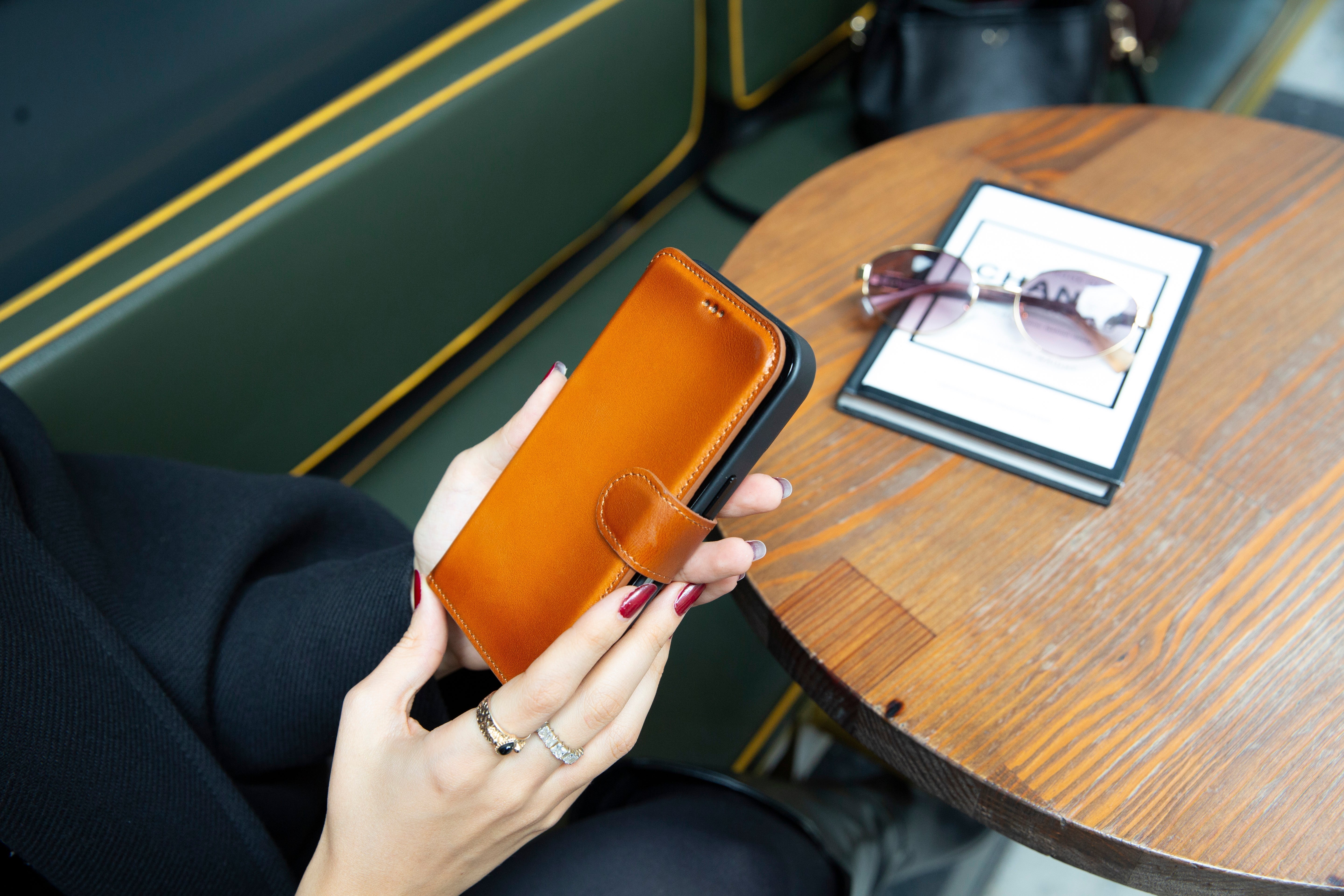 Tan genuine leather folio wallet case for Samsung Galaxy S26 series in a lifestyle setting