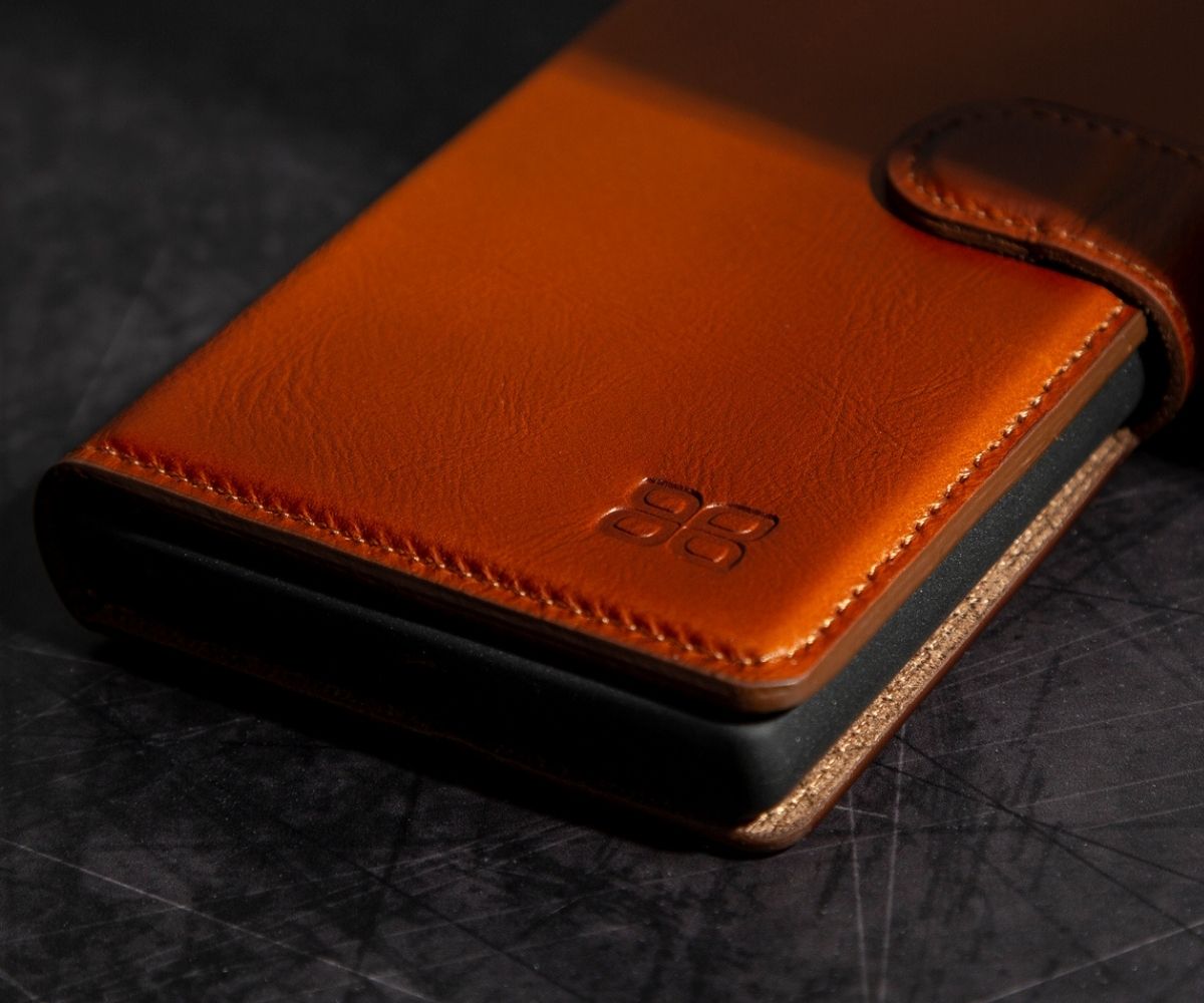 Close up of a tan leather wallet phone case with embossed BoulettaCuir logo