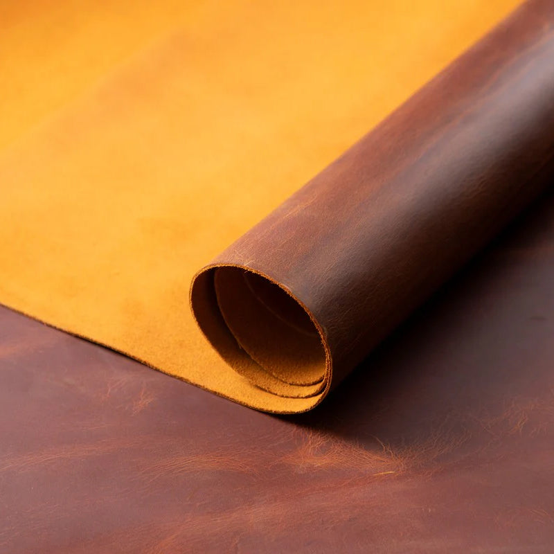 Close-up of a roll of brown leather on an orange background