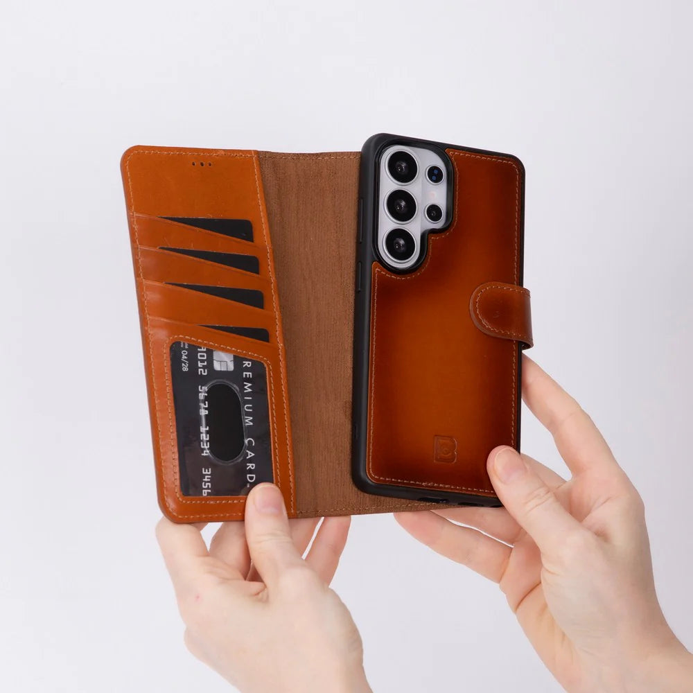 Brown leather phone case with card slots held by hands on a light gray background