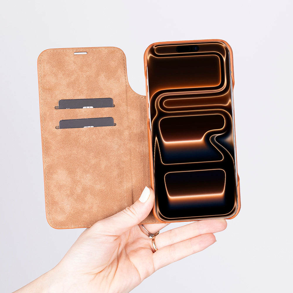 Hand holding aiphone 17 with a brown leather case on a light gray background