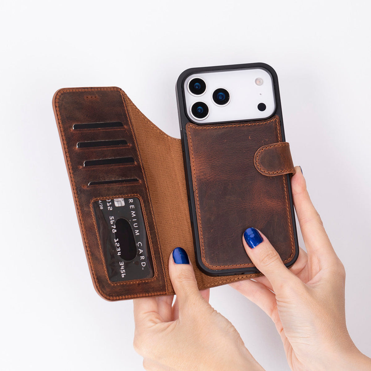 Brown leather phone case with card slots held by a hand on a white background