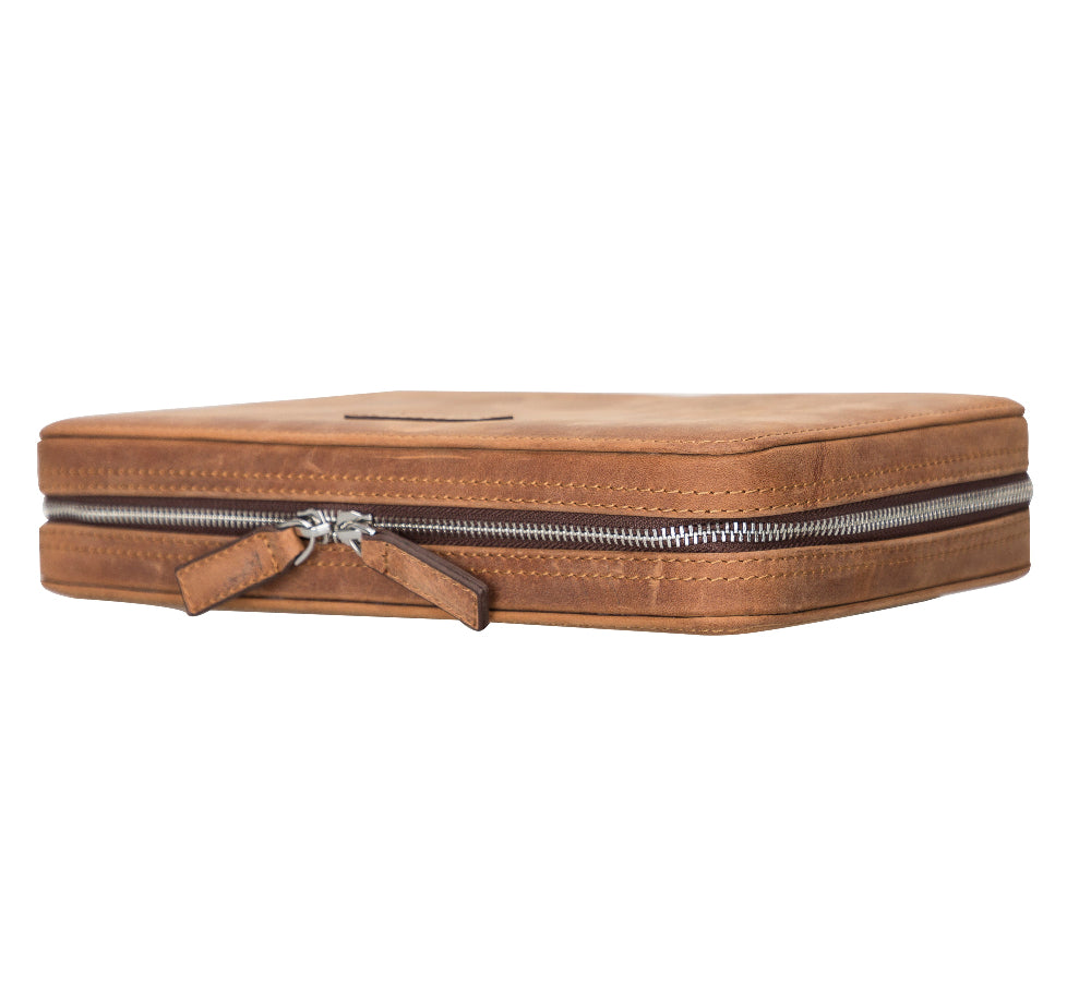Brown leather travel pouch with a zipper on a white background