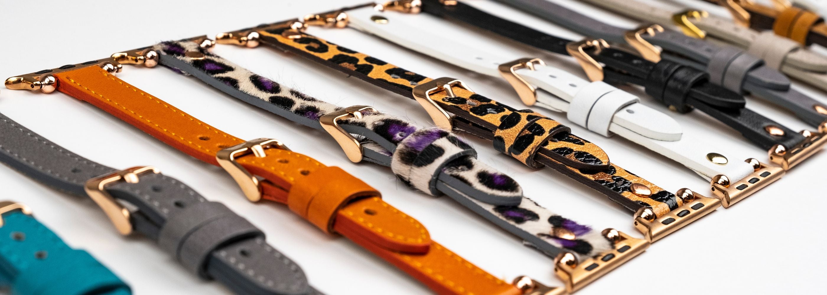 Collection of various leather bracelets on a white background