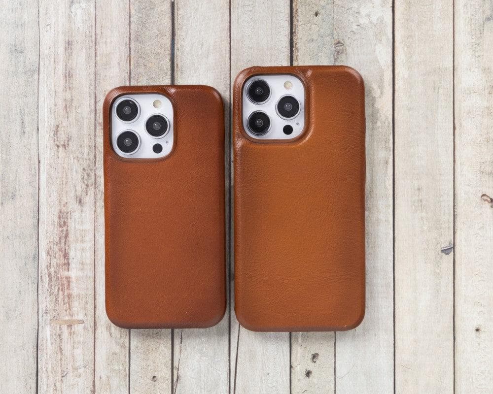 Two brown phone cases on a wooden surface