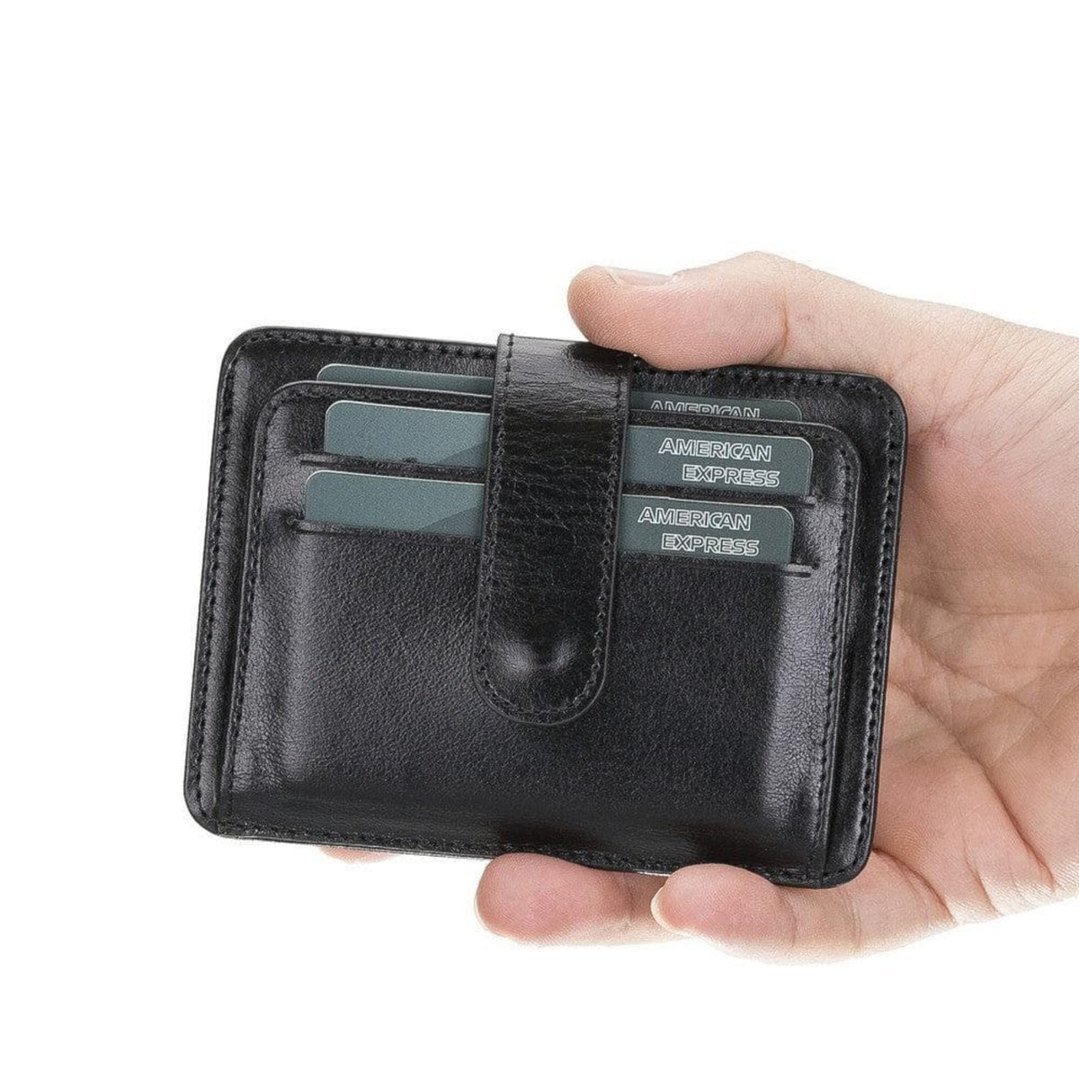 Hand holding a black leather wallet with American Express cards on a white background