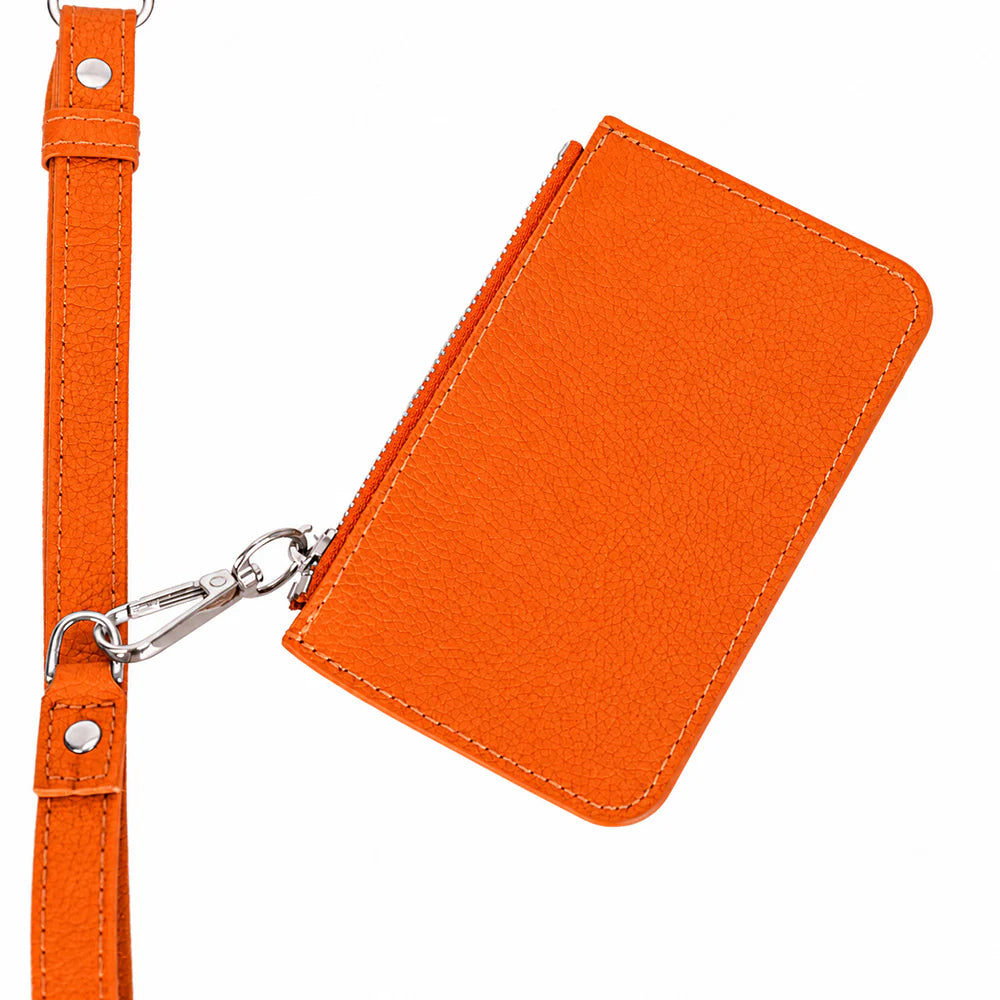 Bright orange textured leather zippered pouch with a matching wrist strap and silver-tone metal hardware, shown on a plain white background.