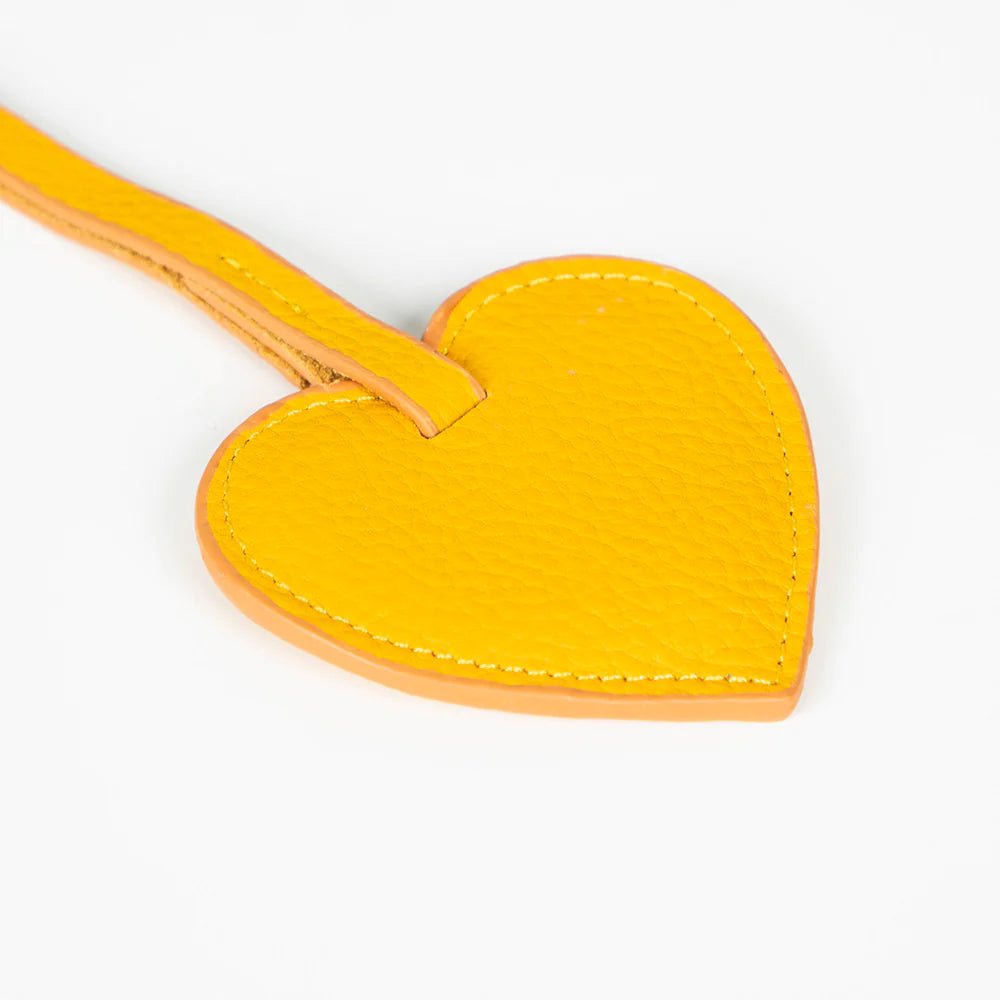 Yellow heart-shaped keychain on a white background