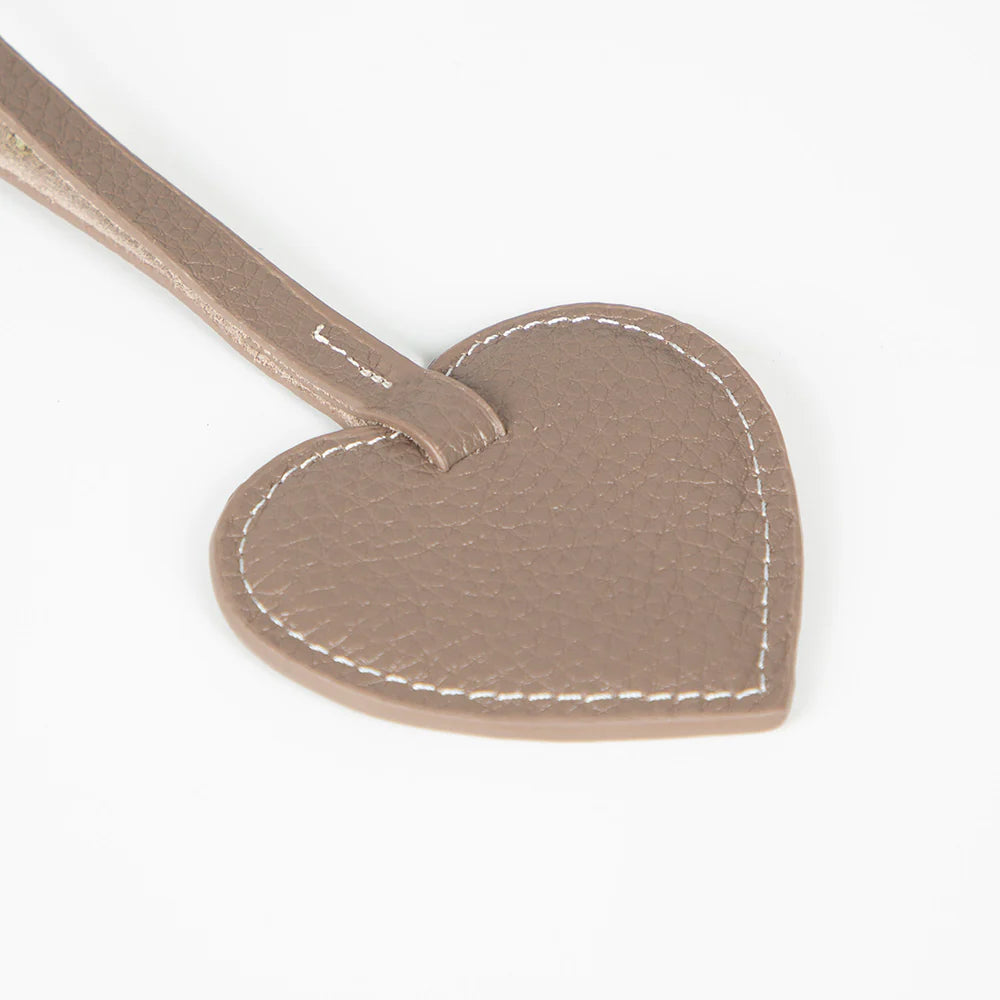 Heart-shaped leather charm  with stitching detail on a white background