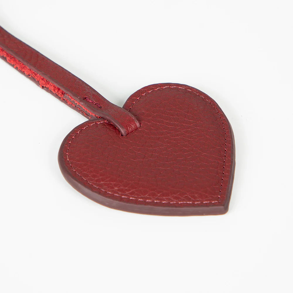 Red heart-shaped charm on a white background