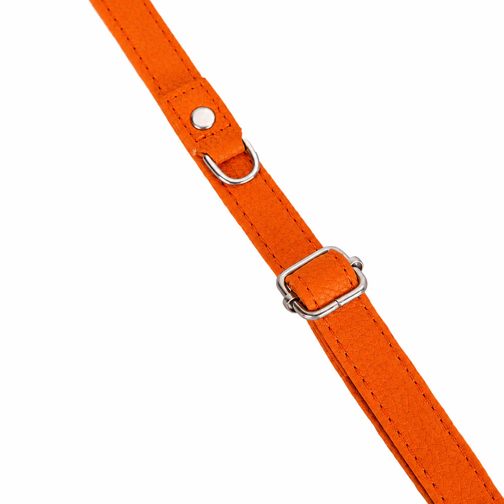 Bright orange faux leather strap with silver metal hardware, including a buckle, D-ring, and rivet, shown on a plain white background.