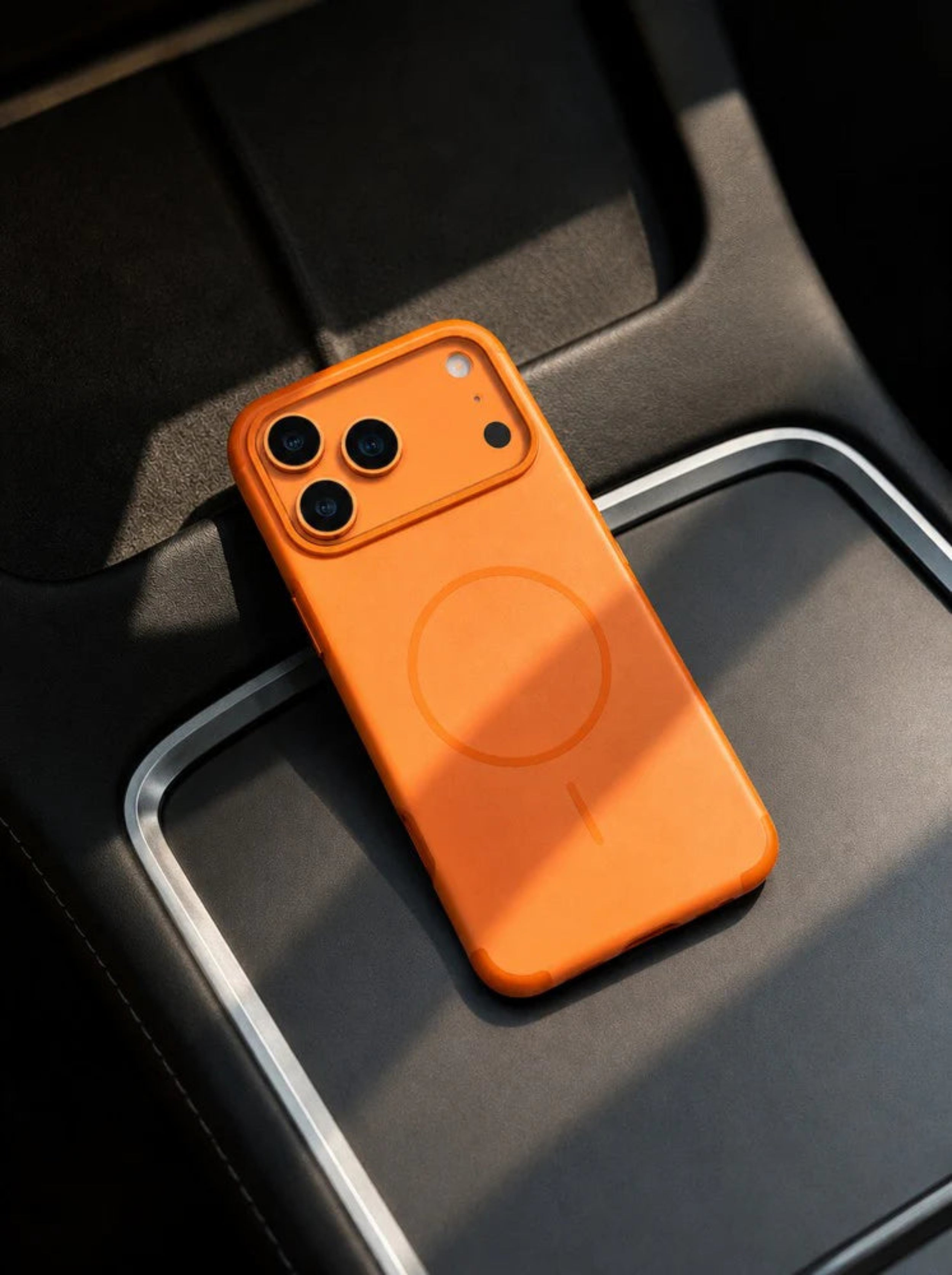 Orange phone case on a car dashboard