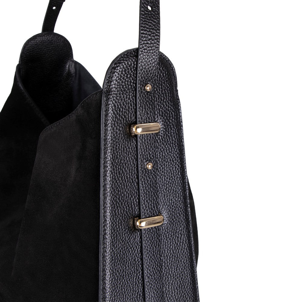Close-up of a textured black bag with gold accents on a white background