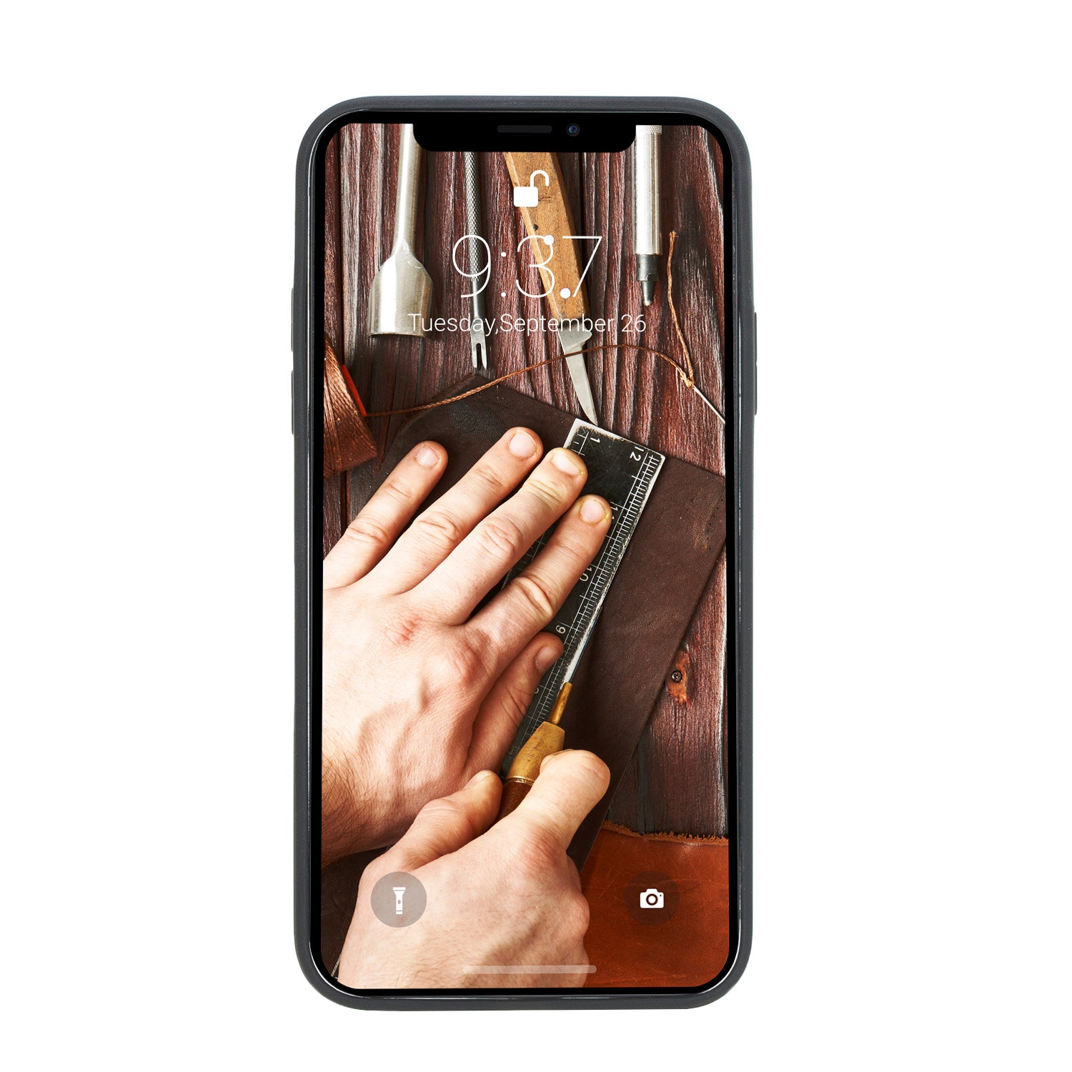 Phone screen displaying a close-up of hands working with tools on a wooden surface
