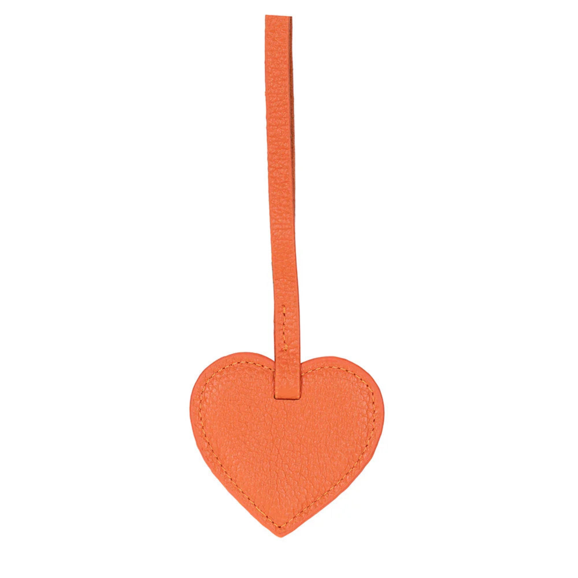 Orange heart-shaped luggage tag with a strap on a white background