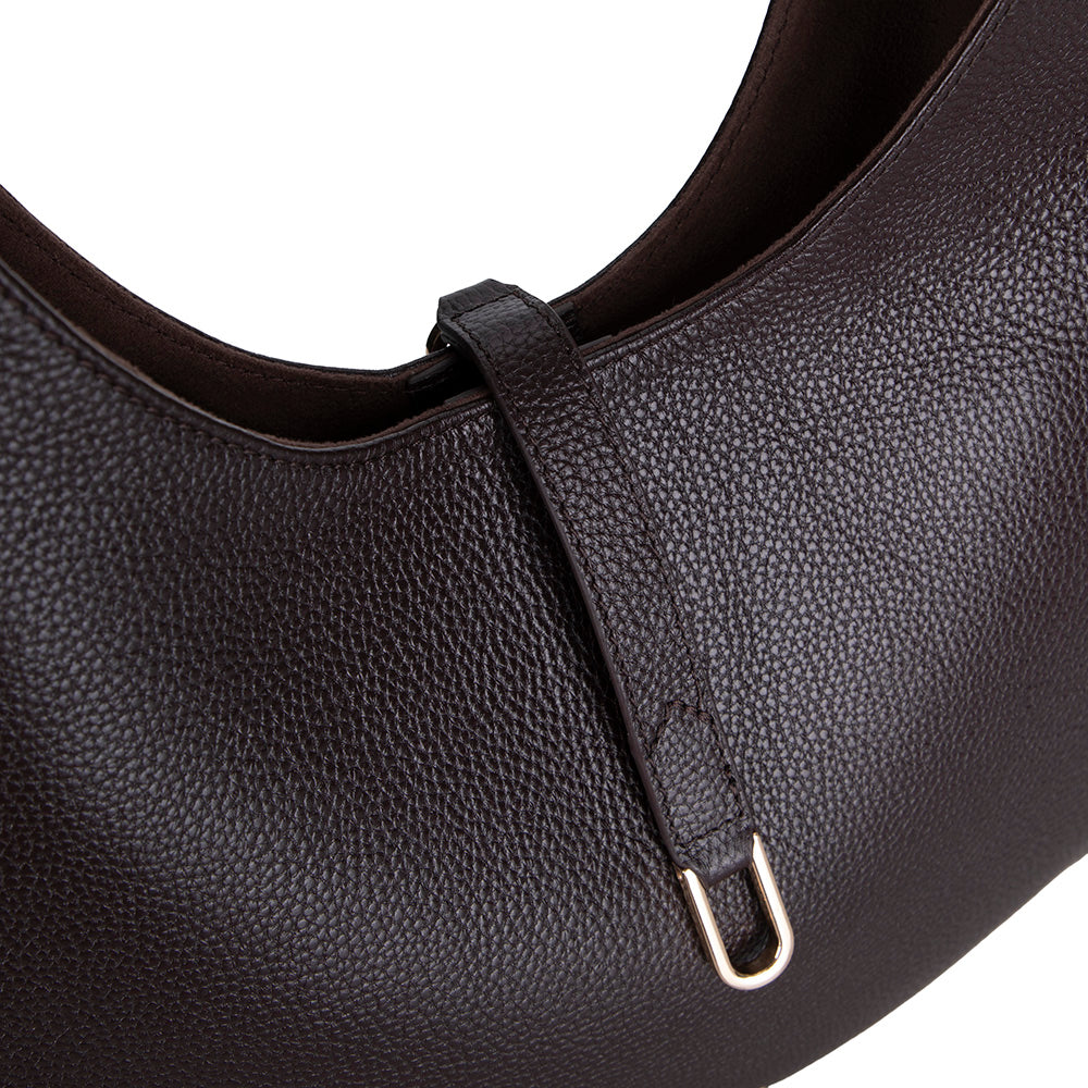 Close-up of a black leather handbag with a shoulder strap on a white background