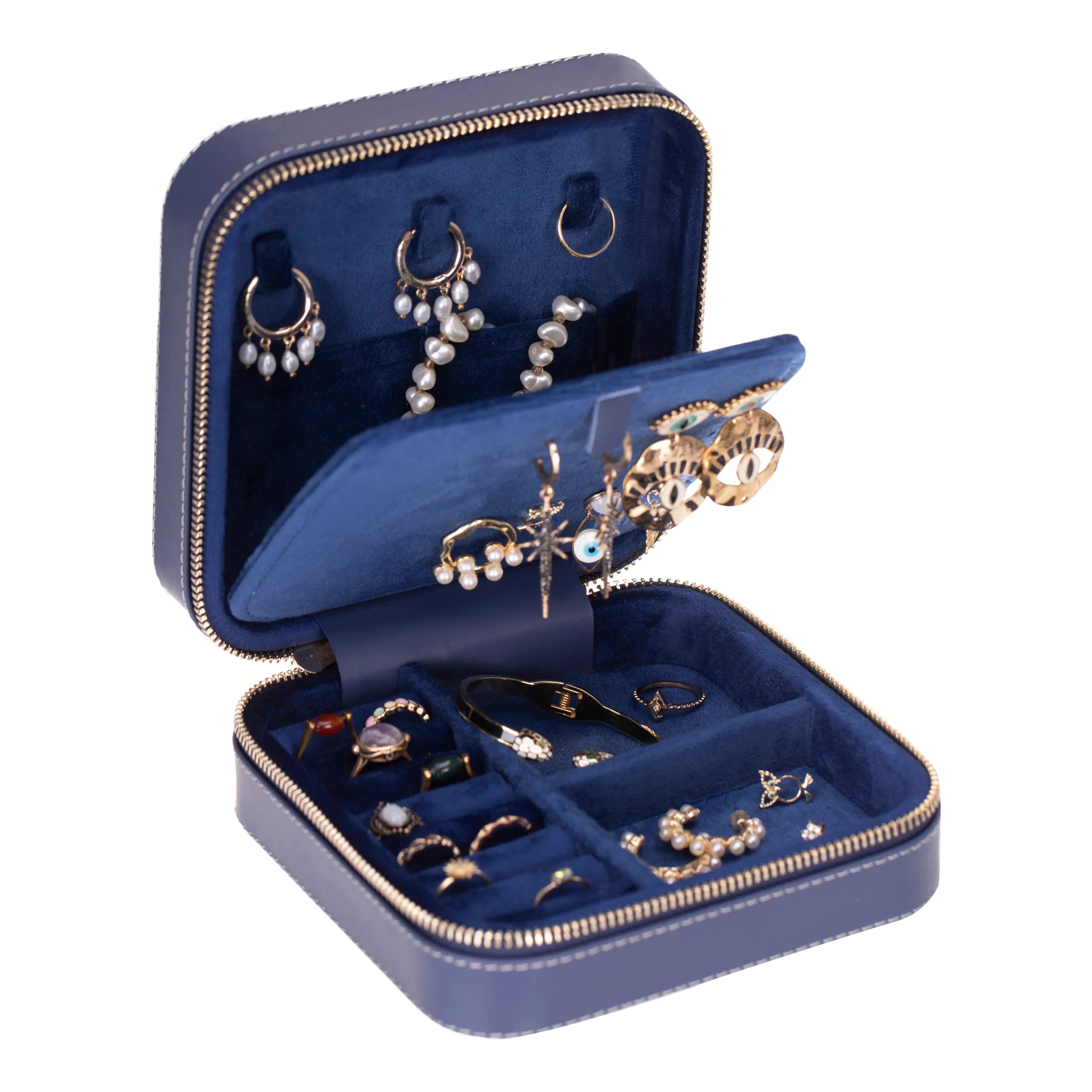 Open blue jewelry box with various earrings inside on a white background