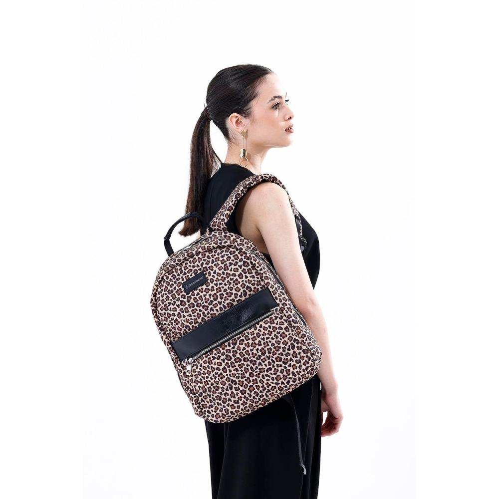 Woman wearing a leopard print backpack on a white background
