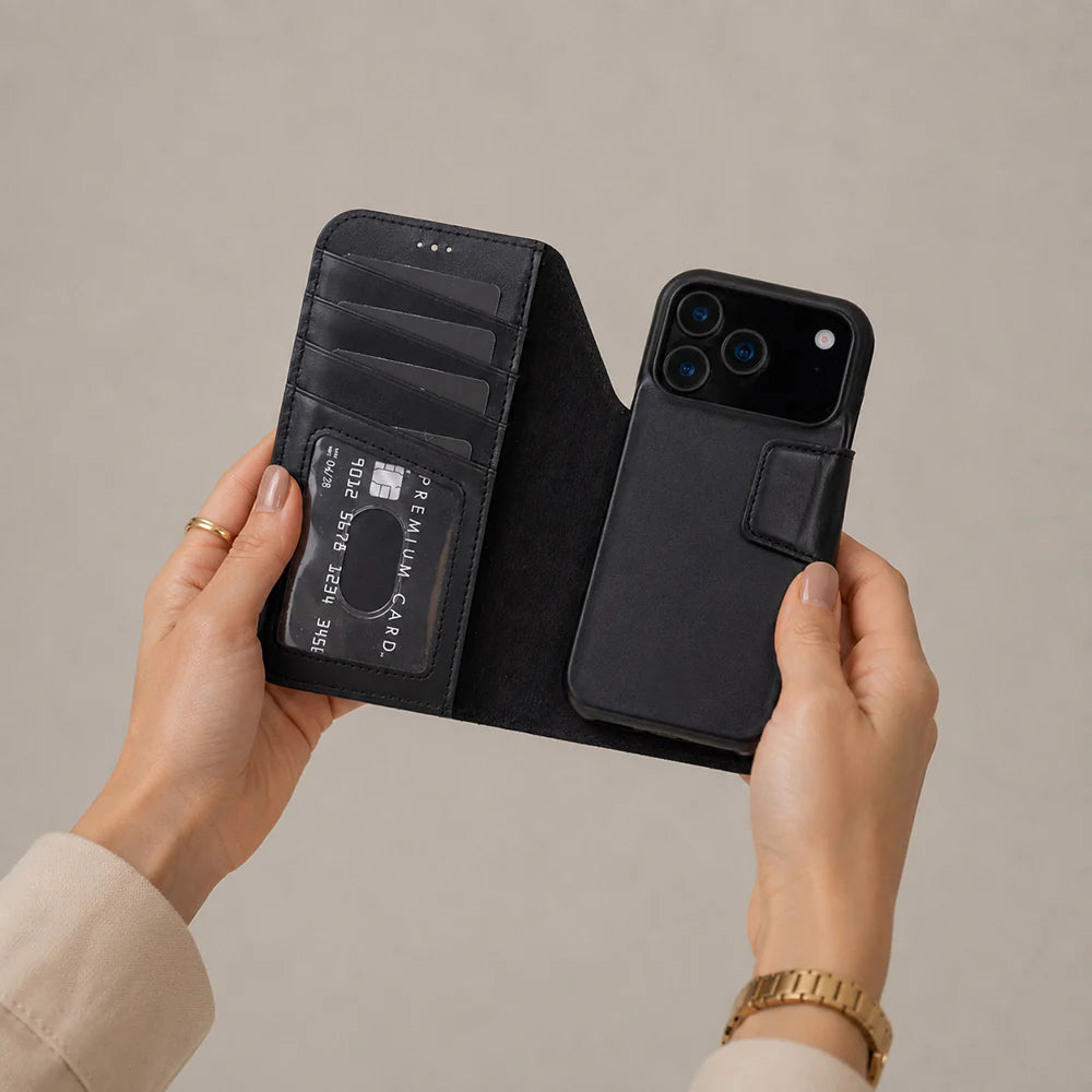 Black iphone 17 pro case with card slots held by hands against a beige background